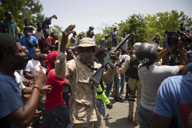Seeking the reasons behind a crisis A political killing and fears of more U.S. evil in Haiti