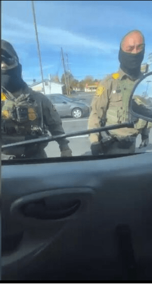 A group of police officers standing in a car AI-generated content may be incorrect.