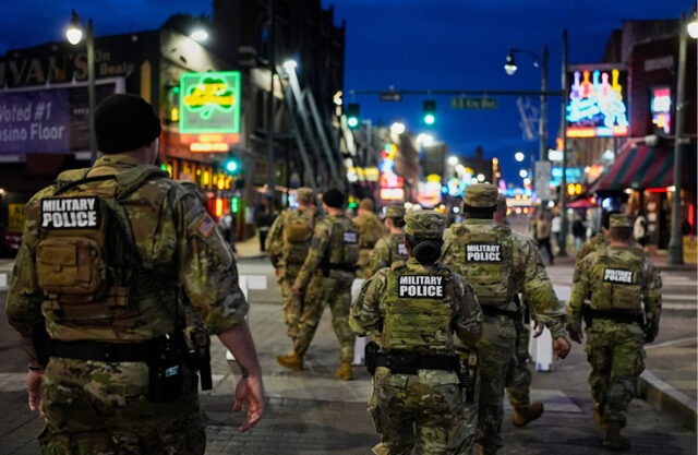 We must unite, resolve our differences or suffer the consequences A group of soldiers walking down a street AI-generated content may be incorrect.