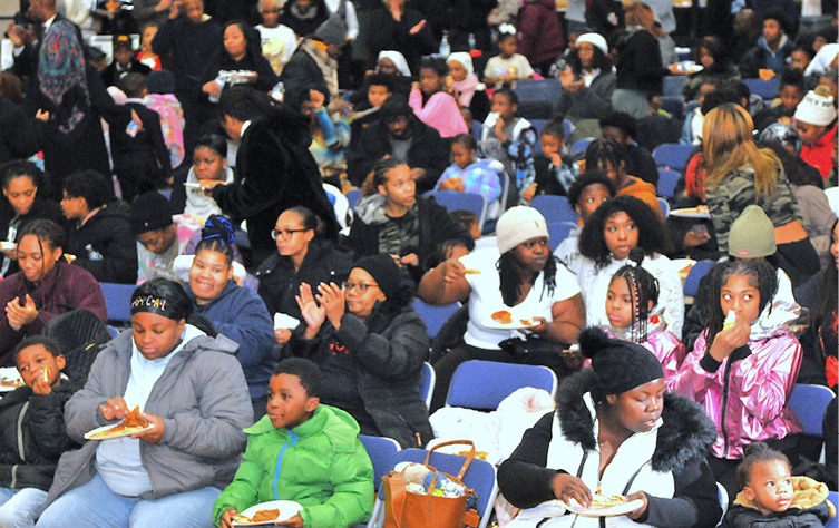 A crowd of people sitting in chairs AI-generated content may be incorrect.