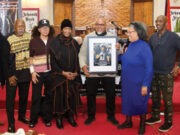 The December 12th Movement celebrates legacy of Viola Plummer with tribute awards A group of people holding a framed picture AI-generated content may be incorrect.