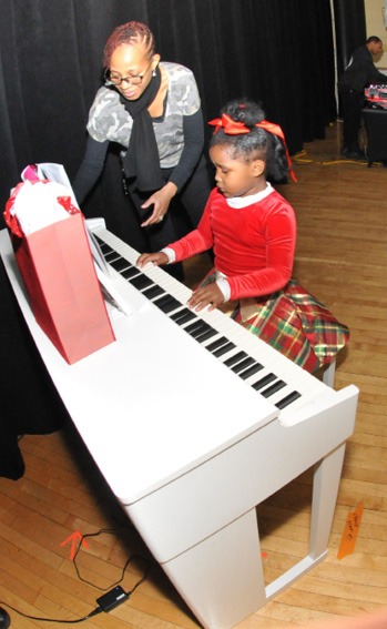 A person and a child playing a piano AI-generated content may be incorrect.
