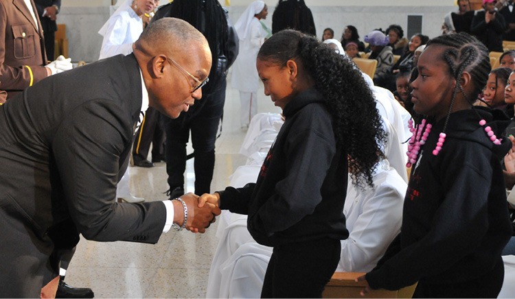 A person shaking hands with a young person AI-generated content may be incorrect.