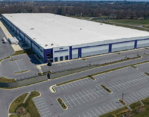 Maryland residents challenge warrantless ICE arrests in federal lawsuit A large industrial warehouse with a white roof and blue accents is surrounded by empty parking lots and roads in a rural area. Description generated by AI